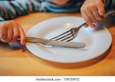 spoon and fork on an empty plate