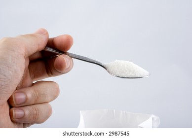 Spoon Full Of Sugar Holding By Hand