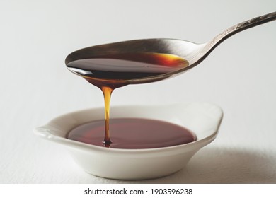 Spoon with Jerusalem artichoke syrup close-up.