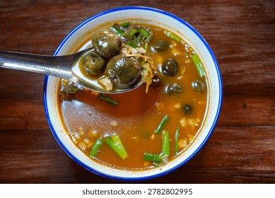 Spoon Lifting Thai Hed Thob Mushroom Soup Close Up, Mushroom Curry with Wild Mushrooms, Traditional Thai Rainy Season Mushroom Soup with Forest Ingredients