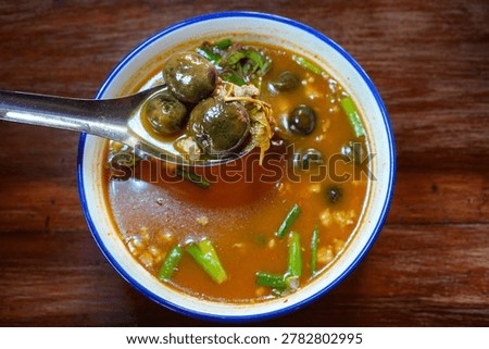 Spoon Lifting Thai Hed Thob Mushroom Soup Close Up, Mushroom Curry with Wild Mushrooms, Traditional Thai Rainy Season Mushroom Soup with Forest Ingredients