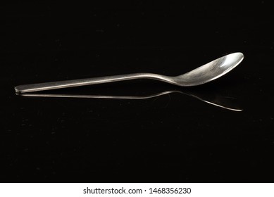 Spoon On A Black Shinny Floor