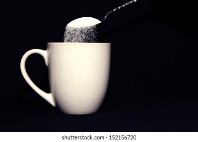 Spoon Pouring A Lot Of Sugar Into Coffee Mug