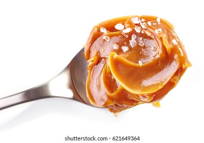 Spoon Of Soft Homemade Salted Caramel Isolated On White Background, Top View