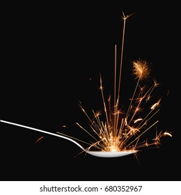 Spoon With Sparkler Isolated On Dark Background. Flavor And Taste Explosion.