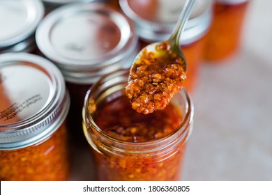 A spoon with Thai Chili Paste / Chili Oil (also called chili oil, or Naam Prik Phao) - Powered by Shutterstock