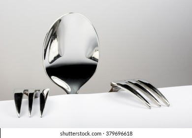 Spoon and two forks formed into conceptual figure - Shutterstock ID 379696618