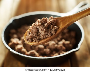 Spoonful Of Freshly Cooked Ground Beef From Iron Skillet