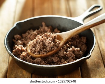 spoonful of freshly cooked ground beef from iron skillet