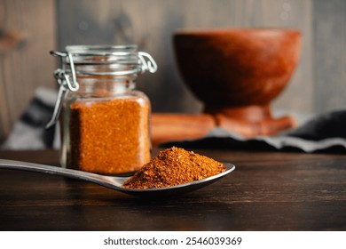 Spoonful of Homemade Berbere Spice Blend Close-up: Side view of East African spice mixture in a spoon with glass jar and mortar and pestle nearby - Powered by Shutterstock