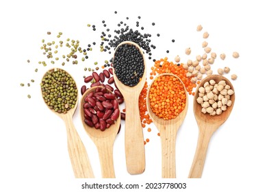 Spoons with different legumes on white background