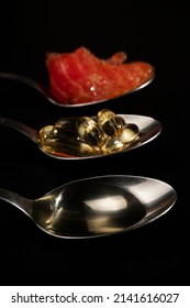 Spoons With Liquid Fish Oil, Ocean Fish Oil Capsules And A Piece Of Salmon. Healthy Eating, Vitamin D3, And A Source Of Omega 3 Polyunsaturated Fatty Acids.