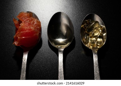 Spoons With Liquid Fish Oil, Ocean Fish Oil Capsules And A Piece Of Salmon. Healthy Eating, Vitamin D3, And A Source Of Omega 3 Polyunsaturated Fatty Acids.