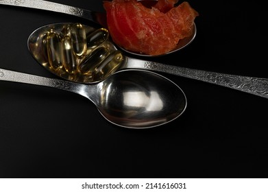 Spoons With Liquid Fish Oil, Ocean Fish Oil Capsules And A Piece Of Salmon. Healthy Eating, Vitamin D3, And A Source Of Omega 3 Polyunsaturated Fatty Acids.