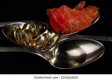 Spoons With Liquid Fish Oil, Ocean Fish Oil Capsules And A Piece Of Salmon. Healthy Eating, Vitamin D3, And A Source Of Omega 3 Polyunsaturated Fatty Acids.