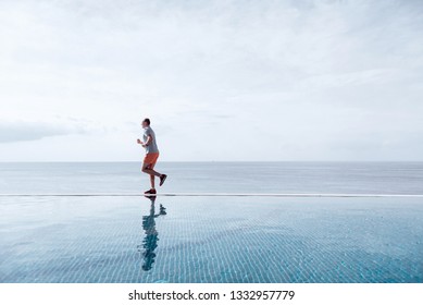 Sport In Adulthood. A Man Over Forty Years Old Doing Morning Jogging.