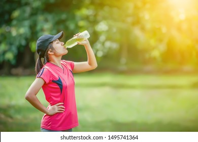 Sport Asian Woman Drinking Water With Electrolytes After Exercise.