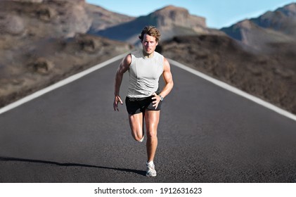 Sport athlete runner man running training endurance on mountain road sprinting fast towards camera. Sprinter exercising for marathon. Young male fitness model on run outdoor in banner landscape. - Shutterstock ID 1912631623