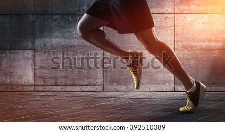 Sport background, close up of urban runner's legs run on the street with copy space