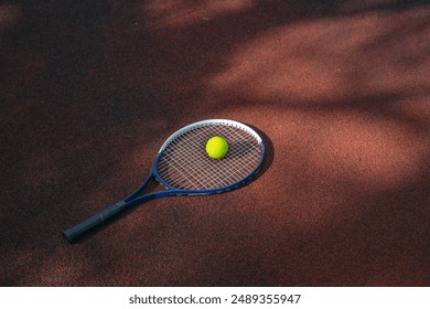 Sport background design dark tone. Closeup tennis ball and racket on line point on clay court. - Powered by Shutterstock