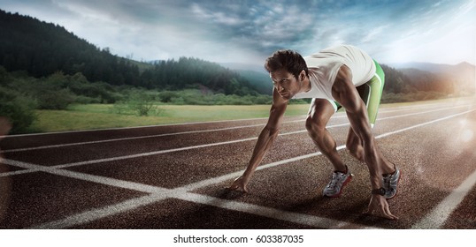 Sport backgrounds. Sprinter starting on the running track. Dramatic image.
