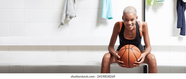 Sport basketball player in the locker room, a smiling African American female athlete holding the ball before the game, competition or training. Woman sitting in changing room with basket ball - Powered by Shutterstock