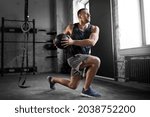 sport, bodybuilding, fitness and people concept - young man exercising with medicine ball in gym