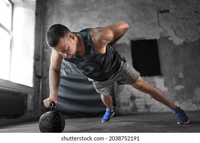 sport, bodybuilding, fitness and people concept - young man doing kettlebell push-ups in gym - Powered by Shutterstock