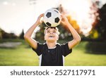 Sport, boy and ball on head with football on field for balance, trick practice and exercise for competition match. Soccer player, person and playing with header for coordination training and fitness