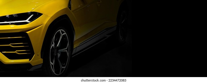 ํYellow sport car headlights on black background	