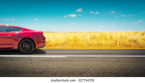 Sport car parked on road side with field of golden wheat background . - Shutterstock ID 527754703