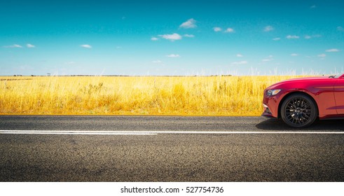 Sport car parked on road side with field of golden wheat background . - Shutterstock ID 527754736