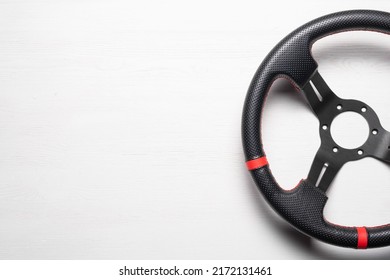 A Sport Car Steering Wheel On The White Flat Lay Background With Copy Space.