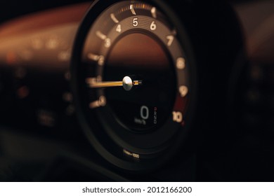 Sport car tachometer and dashboard with backlight. Close up view at modern car dashboard 