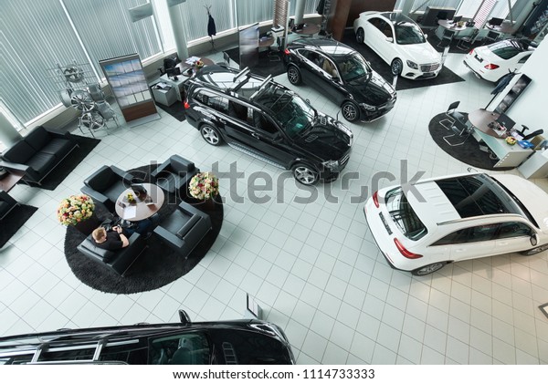 Sport cars in\
luxury auto salon are on\
sale
