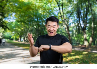 Sport Caucasian Man Looking Smart Watch At Modern Track Runner Using Use Smartwatch Fitness Bracelet Portrait Fit Male Athlete Checking Result Jogging In Sportswear In Street Urban City Park Outdoor