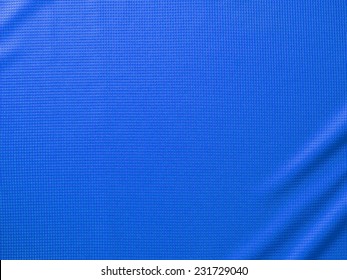 Sport Clothing Fabric Texture Background. Top View Of Cloth Textile Surface. Blue Football Shirt. Text Space