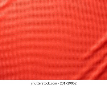 Sport Clothing Fabric Texture Background. Top View Of Cloth Textile Surface. Red Football Shirt. Text Space