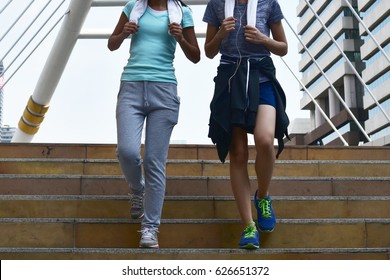 sport  concept :  sport women running and stepping down the stair in the workday morning