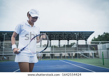 Sport concept; Young people playing tennis on court and relaxing of sport
