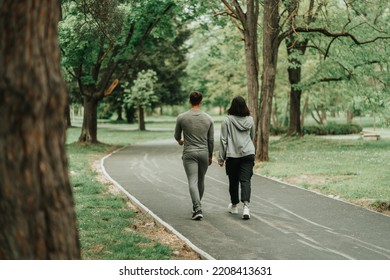 Sport couple walking on the path in the park - Shutterstock ID 2208413631