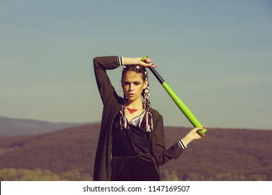 Sport or criminal girl outdoor. Beauty and fashion. Hooligan on blue sky. Bandit gang and conflict. Woman with baseball bat.
