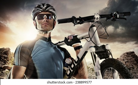 Sport. Cyclist carry a bike on dramatic sky. - Powered by Shutterstock