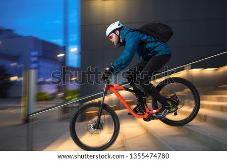 Sport. A cyclist on a bike with a mountain bike in city