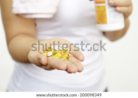 sport and diet concept - woman hand with vitamins and medication 商業照片 © 
