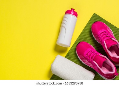 Sport Equipment Flat Lay Image On Color Background. Sneakers, Towel, Yoga Mat And Bottle Of Water. Trayning, Workout And Fitness Concept.