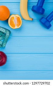 Sport equipment and fruits, top view. Dumbbells, measuring tape, fruits and copy space. Weight loss tips. - Shutterstock ID 1297729702
