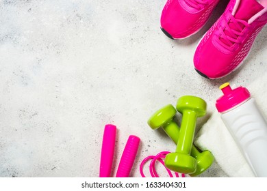 Sport Equipment, Workout Concept For Woman. Flat Lay Image On White Background. Sneakers, Dumbbell, Jump Rope, Towel And Bottle Of Water.