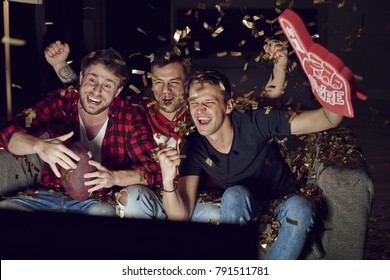 Sport Fan Cheering Among Confetti Falling 
