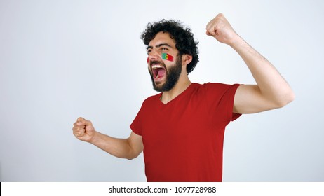 Sport fan screaming for the triumph of his team. Man with the flag of Portugal  makeup on his face and red t-shirt.
        - Powered by Shutterstock